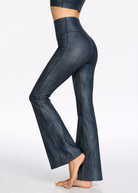 Dark blue flared pants worn by a person on a white background